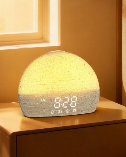 Sunrise alarm clock glowing on a bedside table